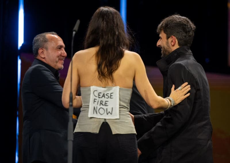 "Cease Fire Now" seen on the back of jury member Verena Paravel as she and Abbas Fahdel (L) present the award for best documentary film for "No Other Land" to directors Yuval Abraham (R) and Basel Adra (Not Pictured) on stage at the closing gala of the 74th Berlin International Film Festival at the Berlinale Palast. Monika Skolimowska/dpa