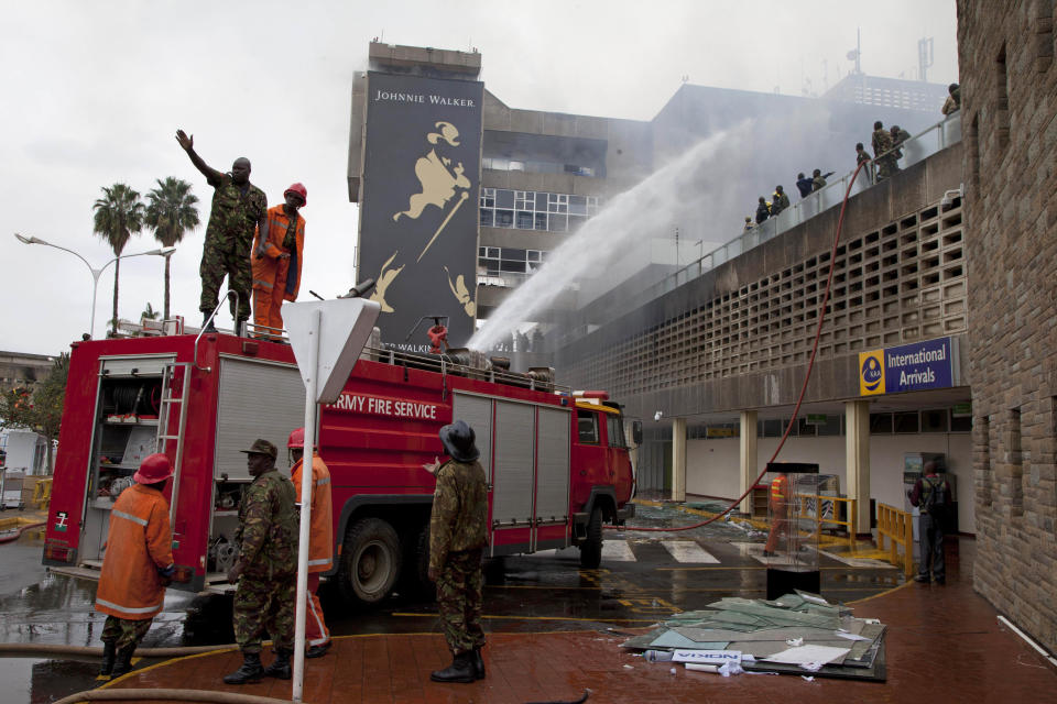 Firefighters put out the fire which gutted the International arrivals area of Jomo Kenyatta International Airport, Nairobi, Kenya, Aug. 7, 2013. A massive fire engulfed the arrivals hall at Kenya's main international airport early Wednesday, forcing East Africa's largest airport to close and the rerouting of all inbound flights. (AP Photo/Sayyid Azim)