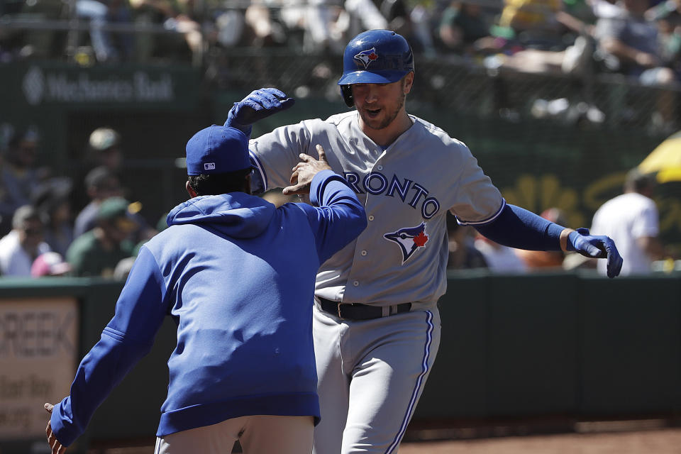 Toronto Blue Jays' Justin Smoak, right, is congratulated by a teammate after hitting a two-run home run against the Oakland Athletics during the seventh inning of a baseball game in Oakland, Calif., Sunday, April 21, 2019. (AP Photo/Jeff Chiu)
