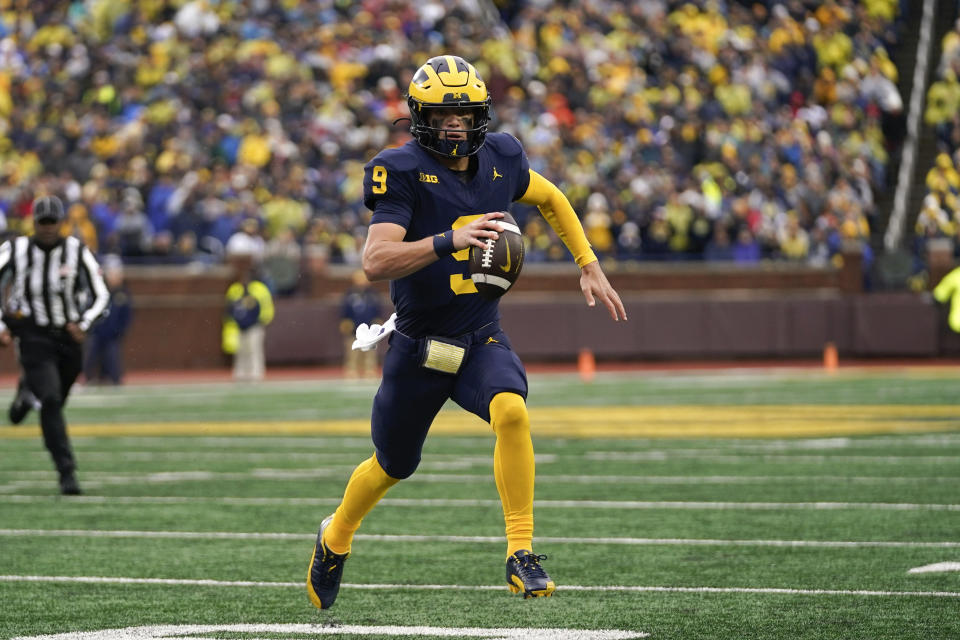 Michigan quarterback J.J. McCarthy (9) rolls out to pass against Indiana in the first half of an NCAA college football game in Ann Arbor, Mich., Saturday, Oct. 14, 2023. (AP Photo/Paul Sancya)