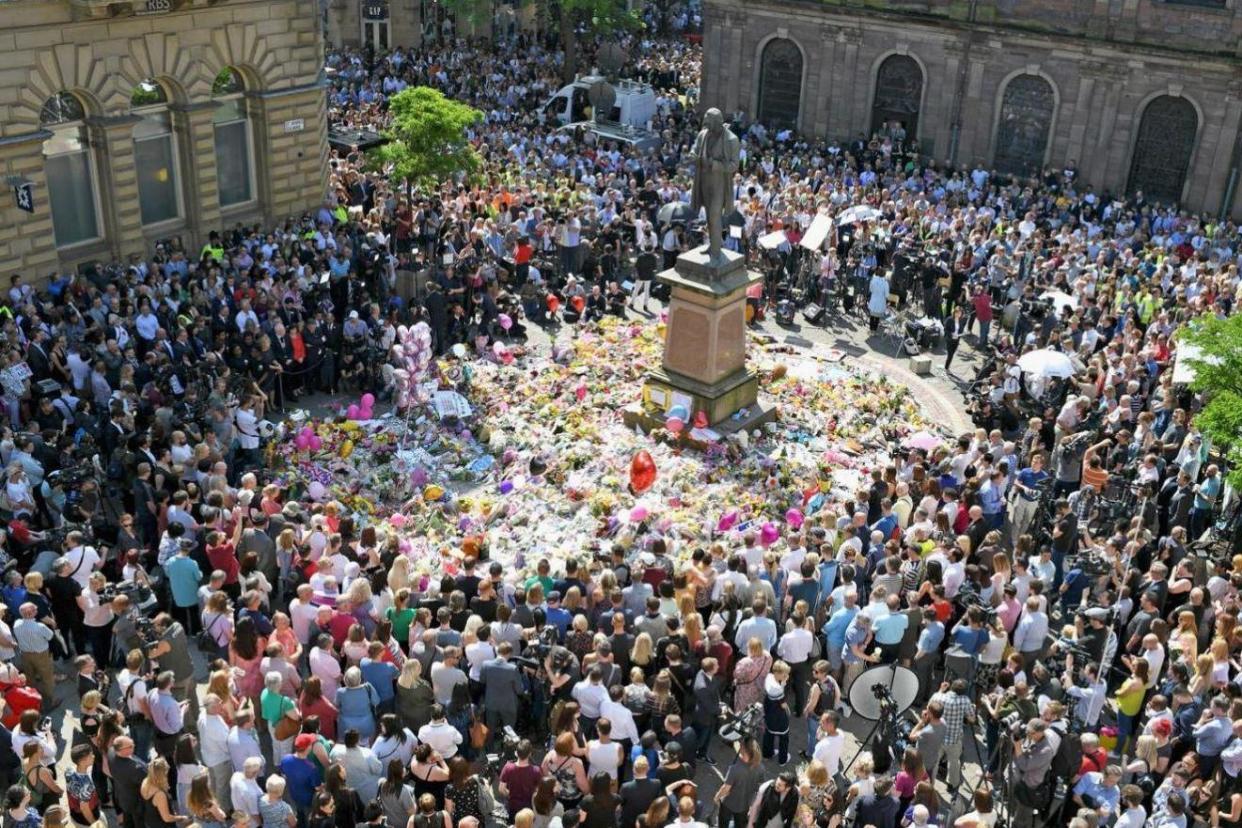 People gather in St Annes Square, Manchester for a minutes silence to mark Manchester attack: Getty