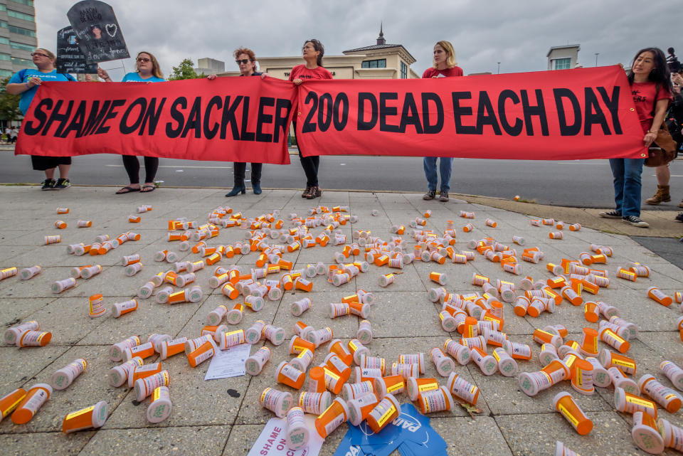 PURDUE PHARMA, STAMFORD, CT, UNITED STATES - 2019/09/12: Members of P.A.I.N. (Prescription Addiction Intervention Now) and Truth Pharm staged a protest on September 12, 2019 outside Purdue Pharma headquarters in Stamford, over their recent controversial opioid settlement. Participants dropped hundreds prescription bottles of OxyContin while holding tombstones with the names of opioids casualties and banners reading "Shame on Sackler" and "200 Dead Each Day". (Photo by Erik McGregor/LightRocket via Getty Images)