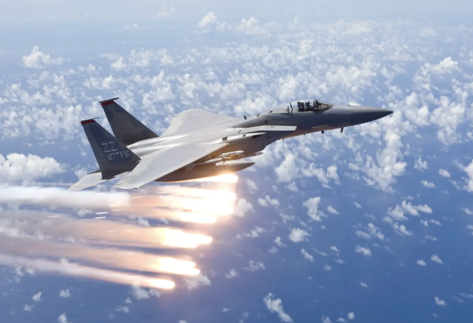 An F-15C from the 67th Fighter Squadron, previously based at Kadena Air Base, Okinawa, Japan, releases flares over the Pacific Ocean during a training mission. <em>Getty Images</em>