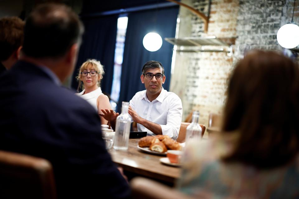 Sunak looks down as he meets with nighttime economy representatives in central London on Saturday (AP)