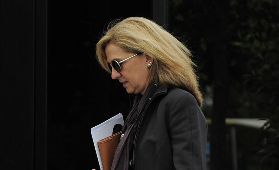 In this April 5, 2013 file photo, Spain's Princess Cristina walks toward her office in Barcelona, Spain. In an unprecedented court appearance on Saturday Feb. 8, 2014 for a direct descendent of a Spanish king, Princess Cristina will answer questions from a judge who has formally named her as a fraud and money laundering suspect. The case is a direct offshoot of one led by the same judge in an investigation of her husband Inaki Urdangarin for allegedly using his position as the Duke of Palma to embezzle public contracts via the Noos Institute, a supposedly nonprofit foundation he set up that channeled money to other businesses. Spain’s royal family just wants the case that has now dragged on for years to end rapidly so the monarchy can try to rebuild the trust it once had. (AP Photo/Manu Fernandez, File)