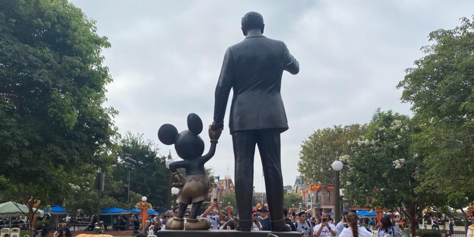 Walt Disney with Mickey Mouse statue.