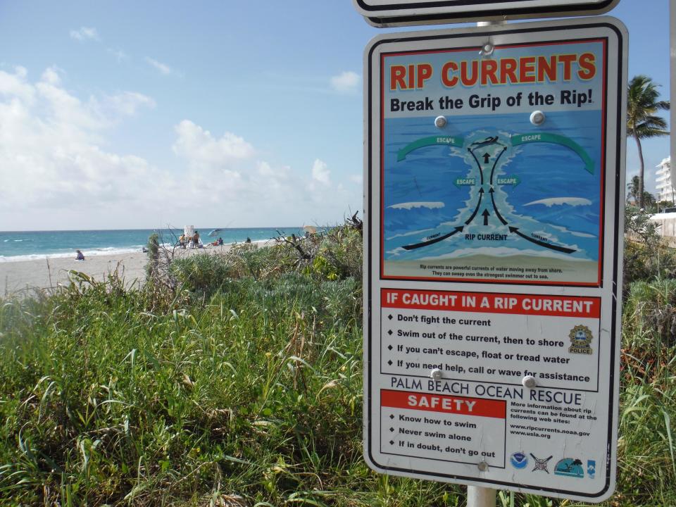 Many beaches have signs like these warning people of the dangers of rip currents and how to get out of them.