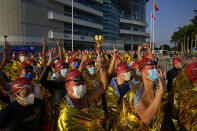 Competitors line up for a harbor race at the Victoria Harbor in Hong Kong, Sunday, Dec. 12, 2021. Hundreds of people took part in traditional swim across iconic Victoria Harbor after two years of suspension. (AP Photo/Kin Cheung)