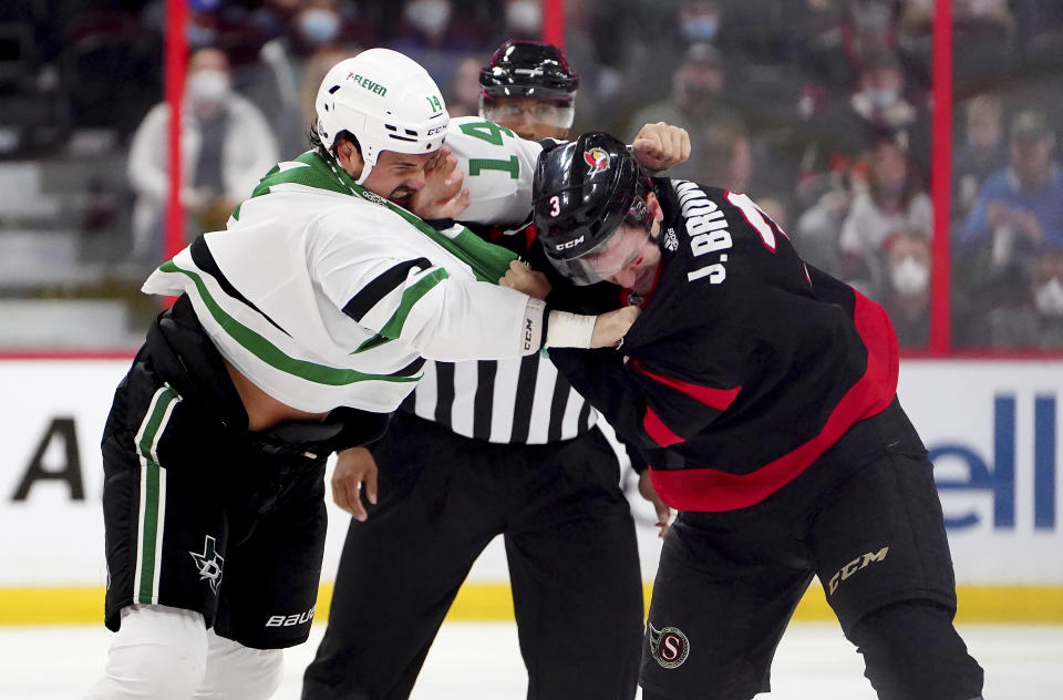 Dallas Stars' Jamie Benn (14) and Ottawa Senators' Josh Brown (3) fight during first-period NHL hockey game action in Ottawa, Ontario, Sunday, Oct. 17, 2021. (Sean Kilpatrick/The Canadian Press via AP)