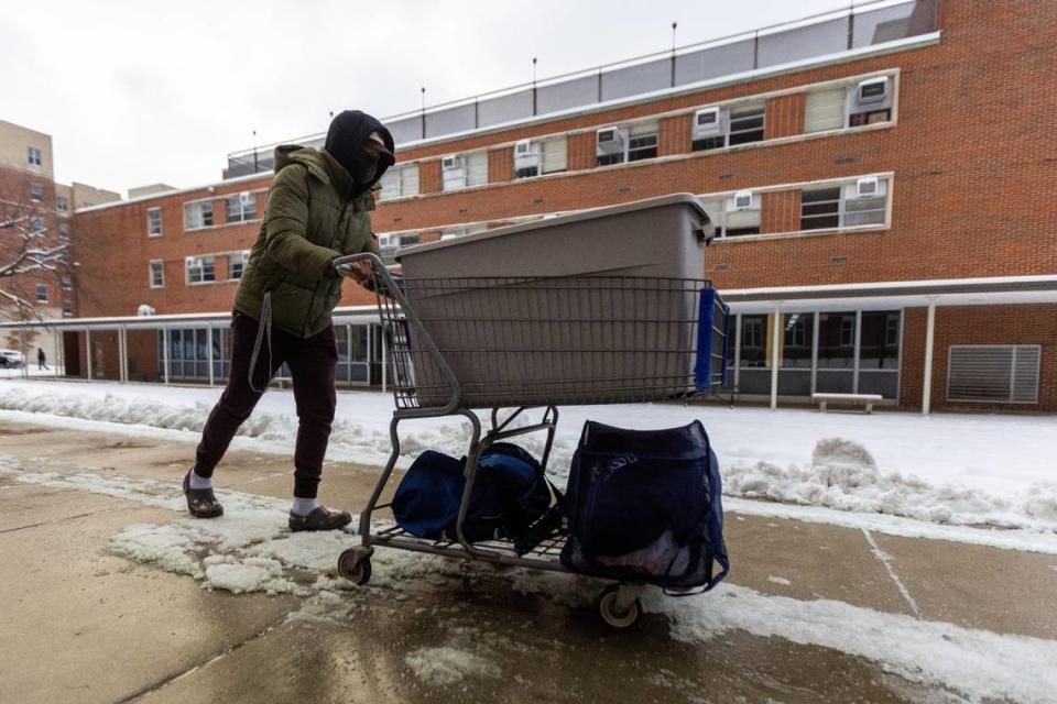 Sophomore Jacob Lee navigates around ice and snow while pushing his cart full of supplies for his dorm room during UKs first move-In day of the Spring semester Friday morning, Jan. 7, 2022.