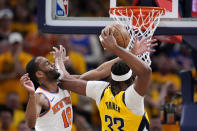 Indiana Pacers center Myles Turner drives to the basket over New York Knicks guard Alec Burks (18) during the first half of Game 3 in an NBA basketball second-round playoff series, Friday, May 10, 2024, in Indianapolis. (AP Photo/Michael Conroy)