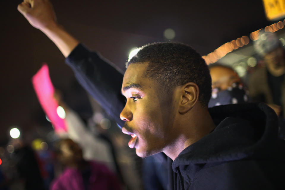 Demonstrators protests in front of the police station on March 12, 2015 in Ferguson, Missouri. Two police officers were shot yesterday while standing outside the station observing a similar protest. Ferguson has faced many violent protests since the August shooting death of Michael Brown by a Ferguson police officer. 