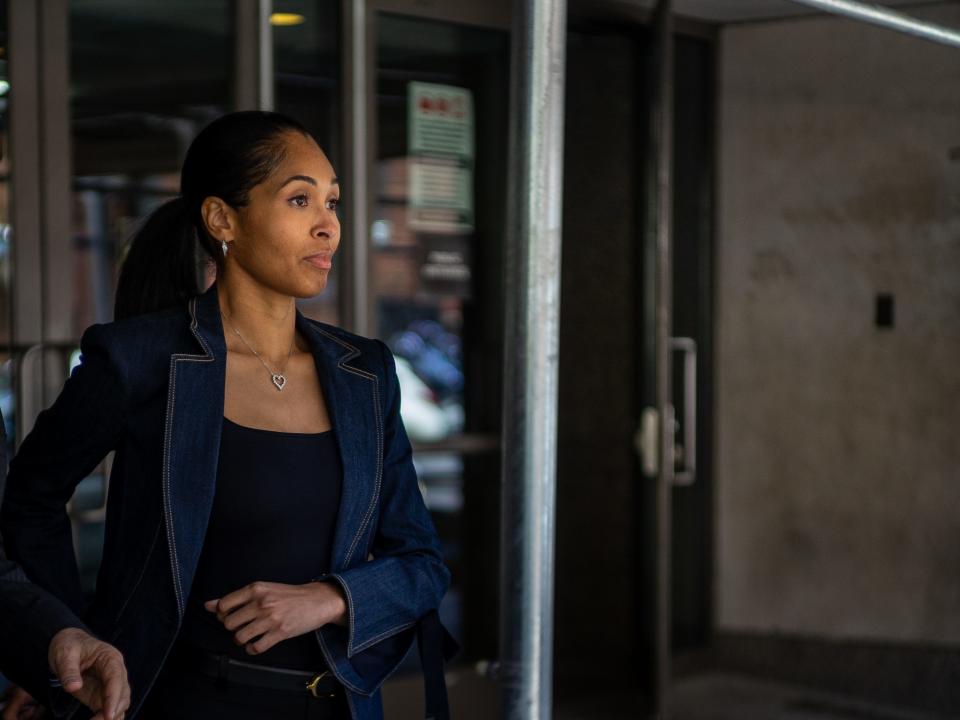 Alexis Adams stepping out of a set of doors outside of Bronx Family Court.