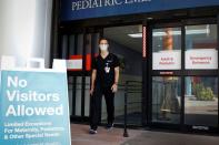 Dennis D'Urso, a resident ER doctor at Jackson Memorial Hospital, walks through a door during his shift amid an outbreak of the coronavirus disease (COVID-19), in Miami