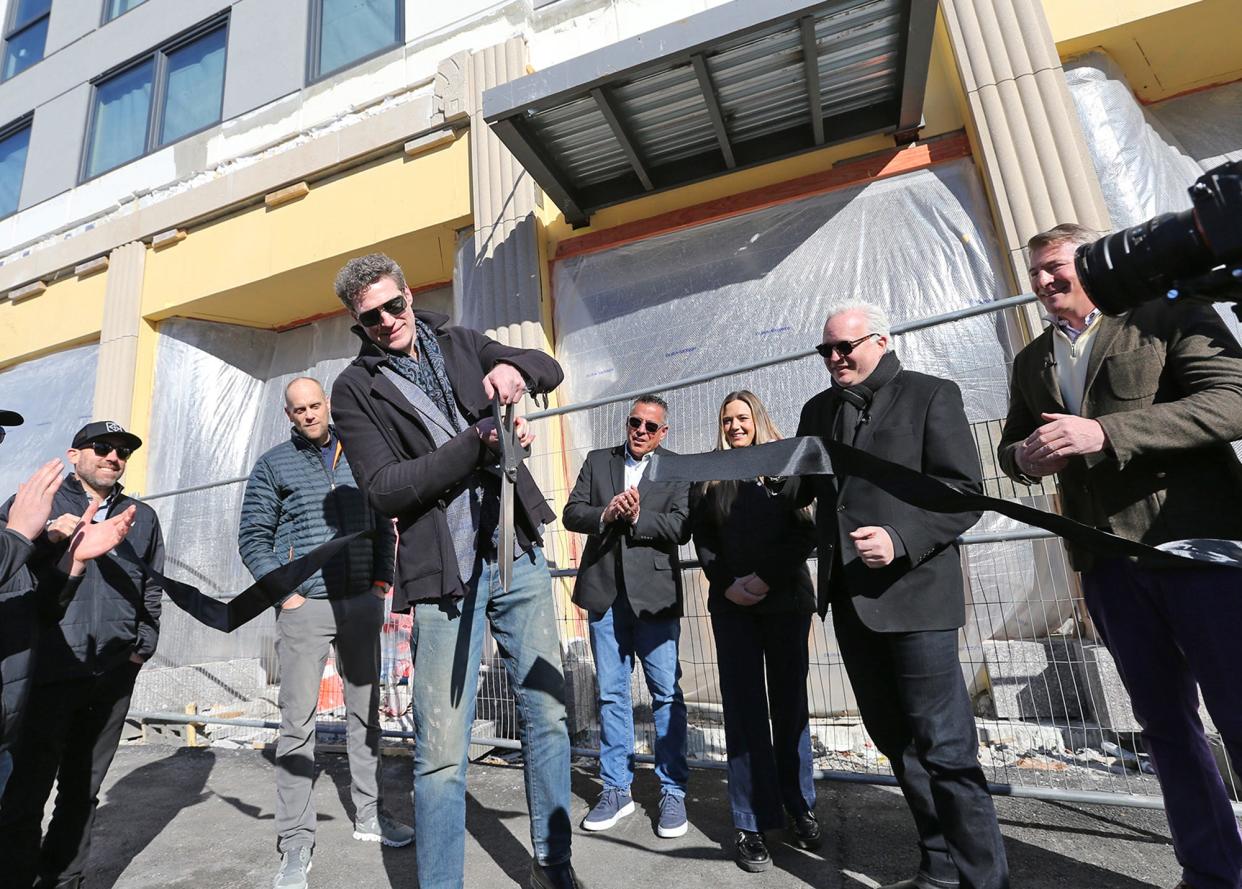 Developer Paul Grant cuts the ribbon for The Howard at 55 North Main St. in Rochester Wednesday, Feb. 7, 2024.