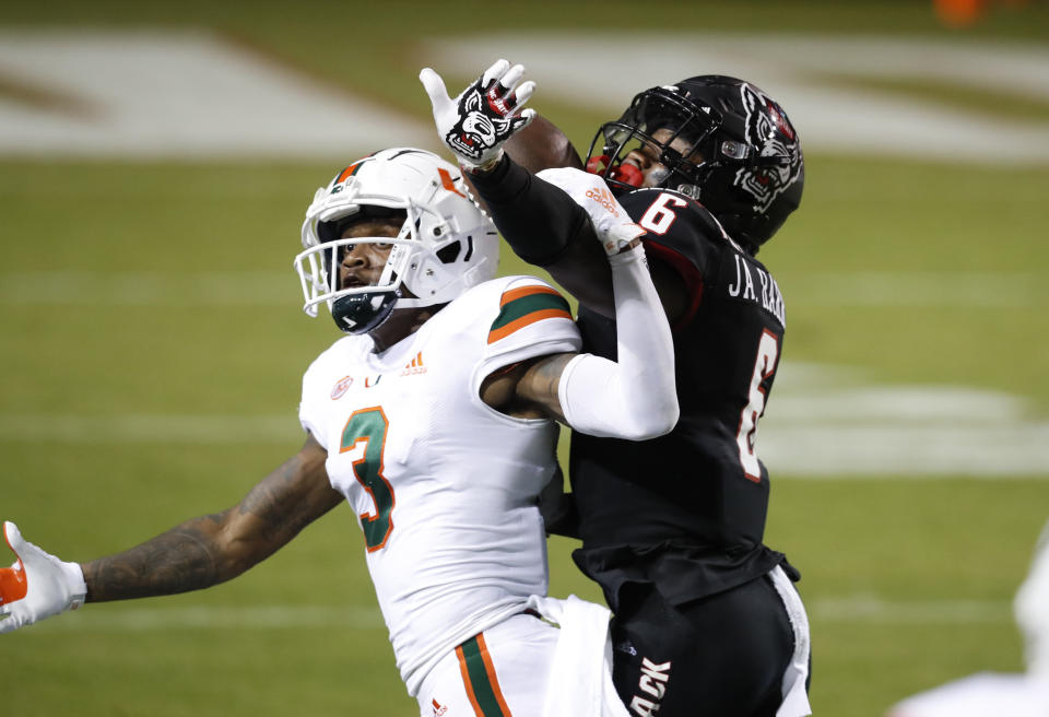 North Carolina State safety Jakeen Harris defends against Miami wide receiver Mike Harley (3) during the first half of an NCAA college football game Friday, Nov. 6, 2020, in Raleigh, N.C. Harris was called for pass interference. (Ethan Hyman/The News & Observer via AP, Pool)