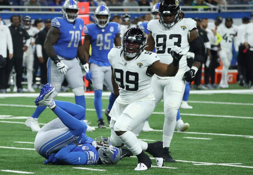 Detroit Lions quarterback Teddy Bridgewater is sacked by Jacksonville Jaguars defensive end Jeremiah Ledbetter (99) during the first half of a preseason game at Ford Field, Saturday, August 19, 2023.