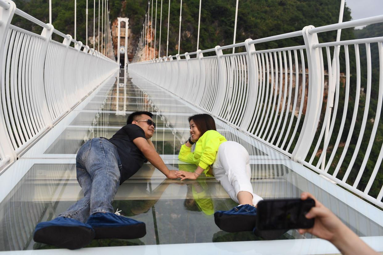 people lie down on the Bach Long glass bridge in the Moc Chau district in Vietnam's Son La province