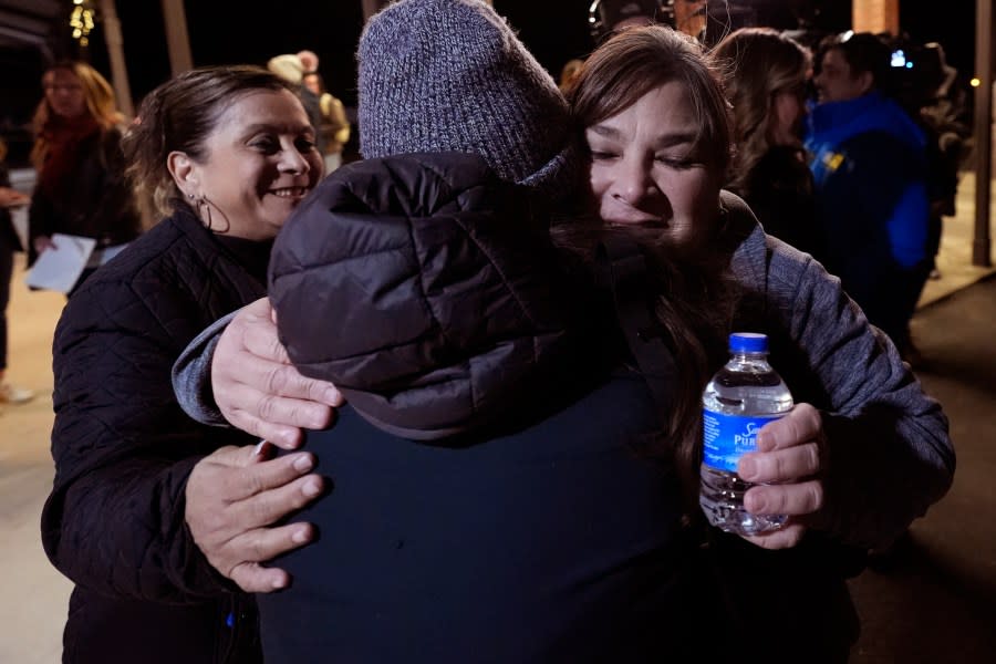 Dora Mendoza, left, and Berlinda Arreola, right, receive hugs as they leave a meeting where Attorney General Merrick Garland shared a report on the findings of an investigation into the 2022 school shooting at Robb Elementary School, Wednesday, Jan. 17, 2024, in Uvalde, Texas. (AP Photo/Eric Gay)