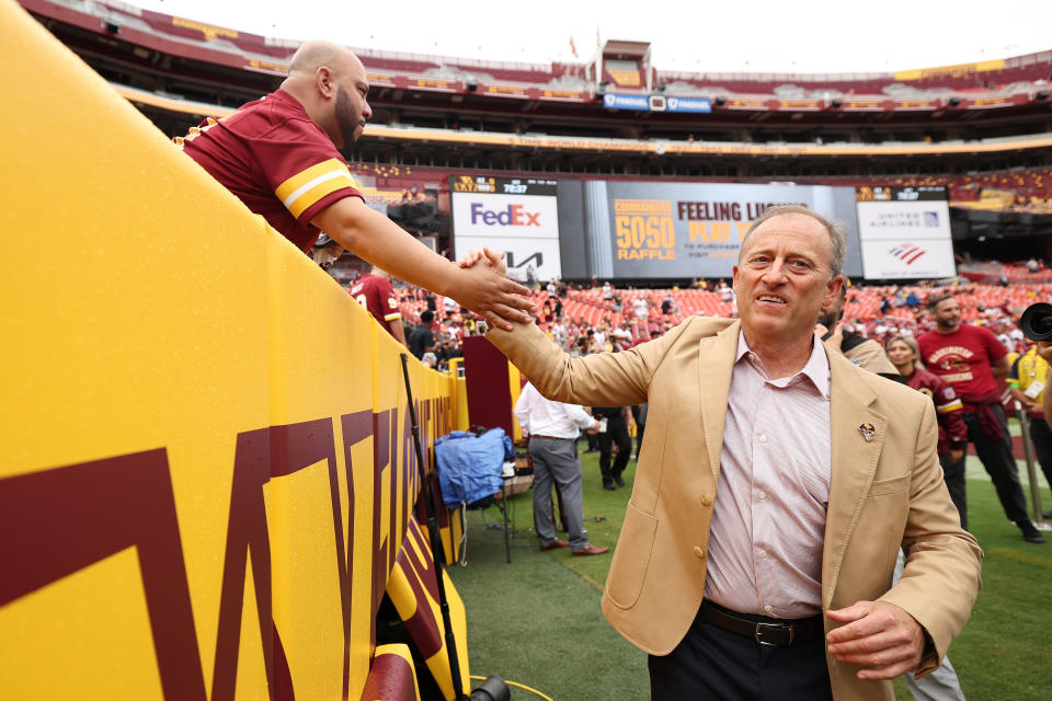 Washington Commanders owner Josh Harris high-fives fans (Photo by Scott Taetsch/Getty Images)