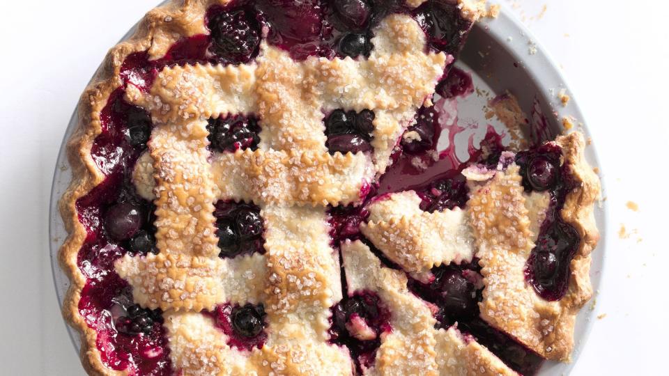 cherry berry jumble fruit pie with a lattice pie crust in a metal pie dish