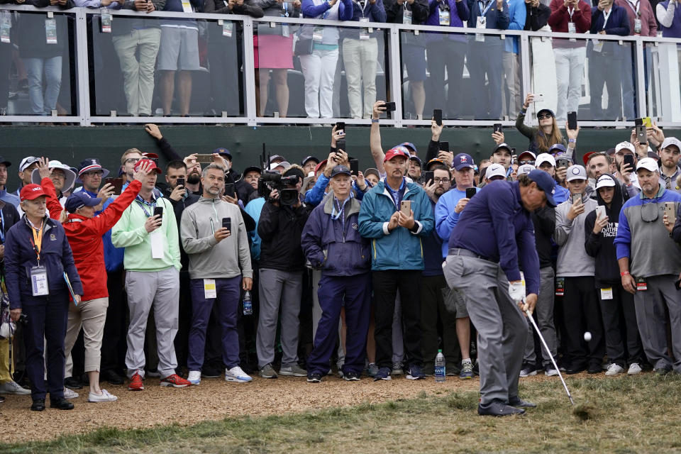 Phil Mickelson hits from the rough on the 18th hole during the second round of the U.S. Open golf tournament Friday, June 14, 2019, in Pebble Beach, Calif. (AP Photo/David J. Phillip)