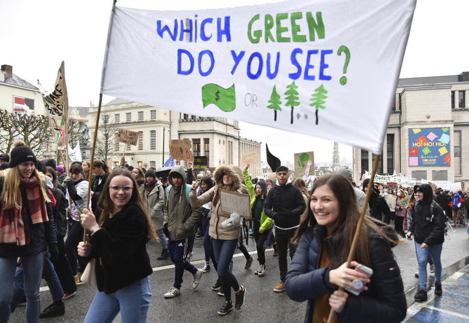 Two girls hold up a banner during a demonstration against climate change in Brussels, Thursday, Jan. 17, 2019. Thousands of students as part of the Youth for Climate movement took time off school Thursday to call for stronger action against climate change. (AP Photo/Geert Vanden Wijngaert)