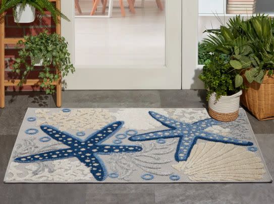 A sea-themed stain-resistant outdoor rug (43% Off)