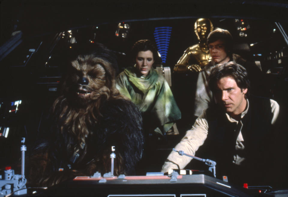 British actors Peter Mayhew, Anthony Daniels, American Carrie Fisher and Harrison Ford on the set of Star Wars: Episode VI - Return of the Jedi directed by Welsh Richard Marquand. (Photo by Sunset Boulevard/Corbis via Getty Images)