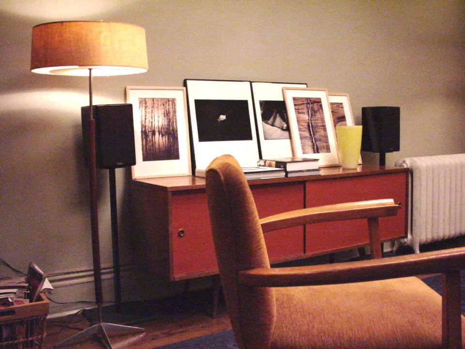 In Carrie's beloved apartment, a midcentury-style credenza displays plenty of art.
