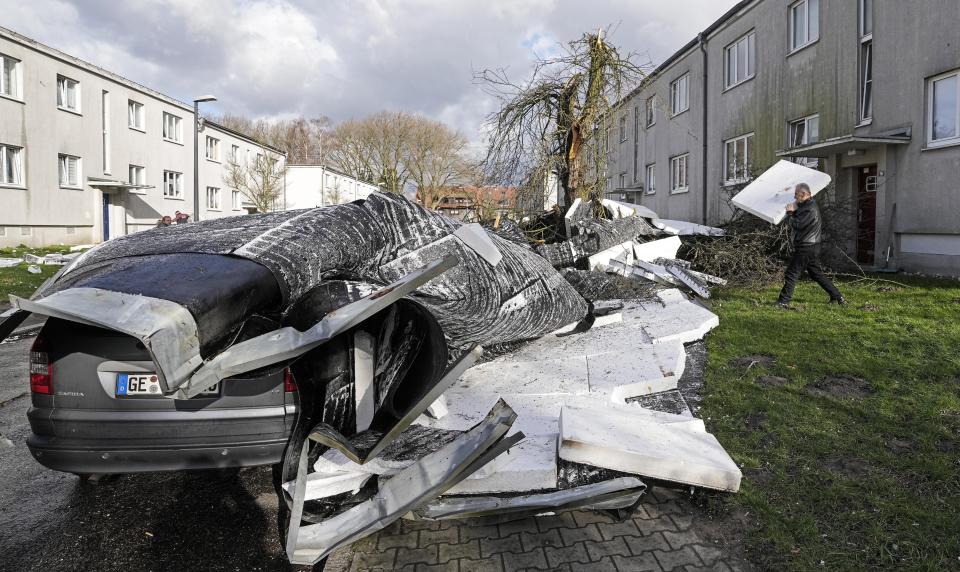 A storm has blown a roof of an apartment house on a street in Gelsenkirchen, Germany, Thursday, Feb. 17, 2022. Meteorologists warned Thursday that northern Europe could be battered by a series of storms over the coming days after strong winds swept across Germany, Denmark, Poland and the Czech Republic overnight, toppling trees and causing widespread delays to rail and air traffic. (AP Photo/Martin Meissner)