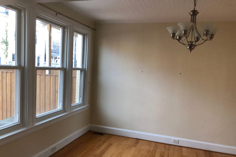 Bare room with hanging light fixture.