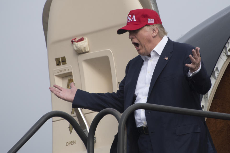 President-elect Donald Trump reacts as he walks off his plane as members of the Azalea Trail Maids wait for his arrival in Mobile, Alabama, for a Thank You Tour 2016 rally on Dec. 17, 2016.