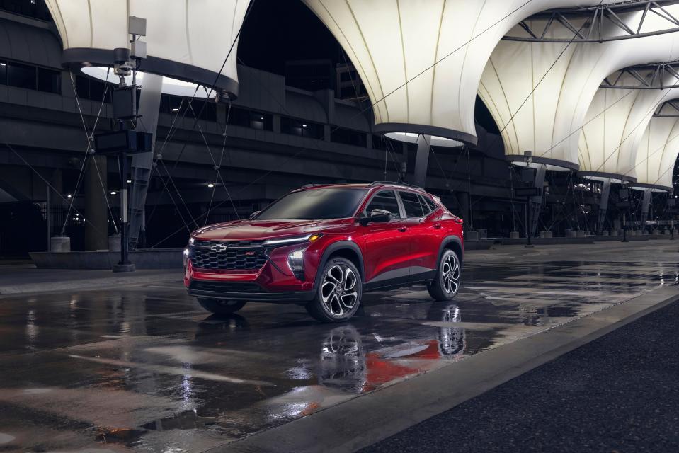 Driver’s side view of 2024 Chevrolet Trax RS in Crimson Metallic parked on a street. Pre-production model shown. Actual production model may vary. Available in spring 2023.