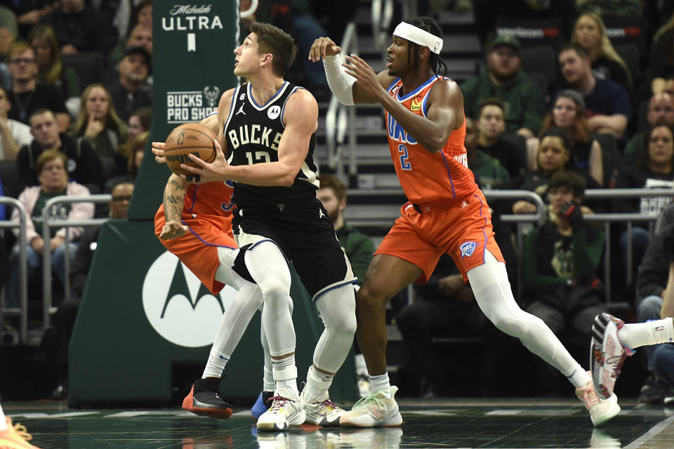 Milwaukee Bucks guard Grayson Allen, front left, looks to the basket under coverage by Oklahoma City Thunder guard Shai Gilgeous-Alexander (2) during the first half of an NBA basketball game Saturday, Nov. 5, 2022, in Milwaukee. (AP Photo/Kayla Wolf)