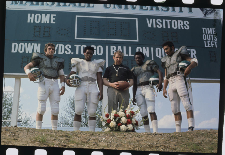 The only four remaining starters from Marshall's 1970 football team alongside the new head coach. (Bettmann Archives/Getty Images)