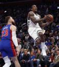 Milwaukee Bucks guard Eric Bledsoe, right, makes a layup as Detroit Pistons forward Blake Griffin (23) watches during the first half of Game 3 of a first-round NBA basketball playoff series, Saturday, April 20, 2019, in Detroit. (AP Photo/Carlos Osorio)