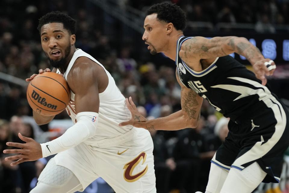 Cleveland Cavaliers' Donovan Mitchell drives past Milwaukee Bucks' George Hill during the first half of an NBA basketball game Friday, Nov. 25, 2022, in Milwaukee. (AP Photo/Morry Gash)