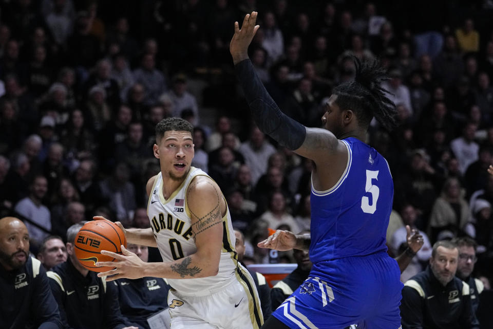 Purdue forward Mason Gillis (0) looks to pass the ball around New Orleans forward Tyson Jackson (5) during the second half of an NCAA college basketball game in West Lafayette, Ind., Wednesday, Dec. 21, 2022. (AP Photo/Michael Conroy)