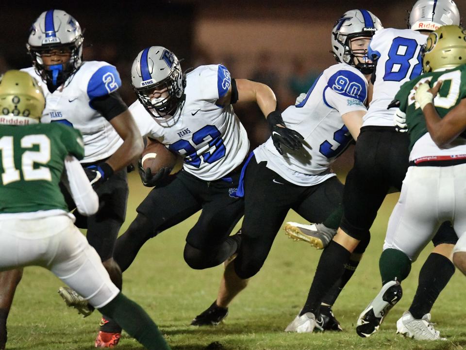 With help from teammate Jake George (90) opening up a hole for him, Bartram Trail Bears Laython Biddle (33) finds running room during third quarter action against the Fleming Island Golden Eagles. Fleming Island played host to Bartram Trail for Friday night football, September 29, 2023.