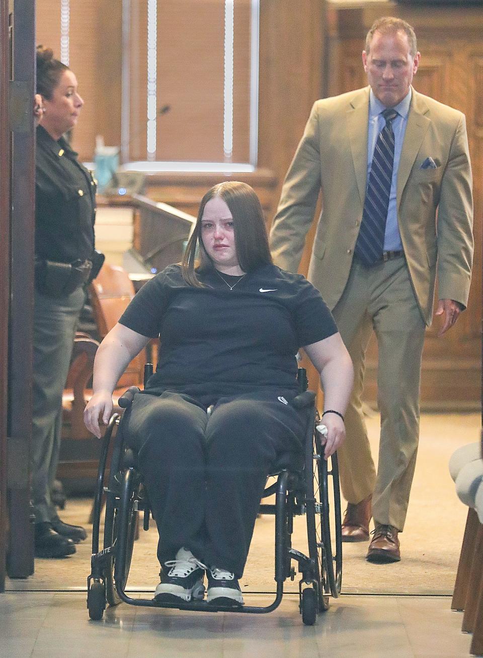 Jessica Skinner leaves a Summit County courtroom Wednesday with her attorney Tom Bauer after she pleaded guilty to aggravated vehicular homicide. Skinner, who was left paralyzed by the crash that fatally injured a Canton woman, will be sentenced Oct. 11.