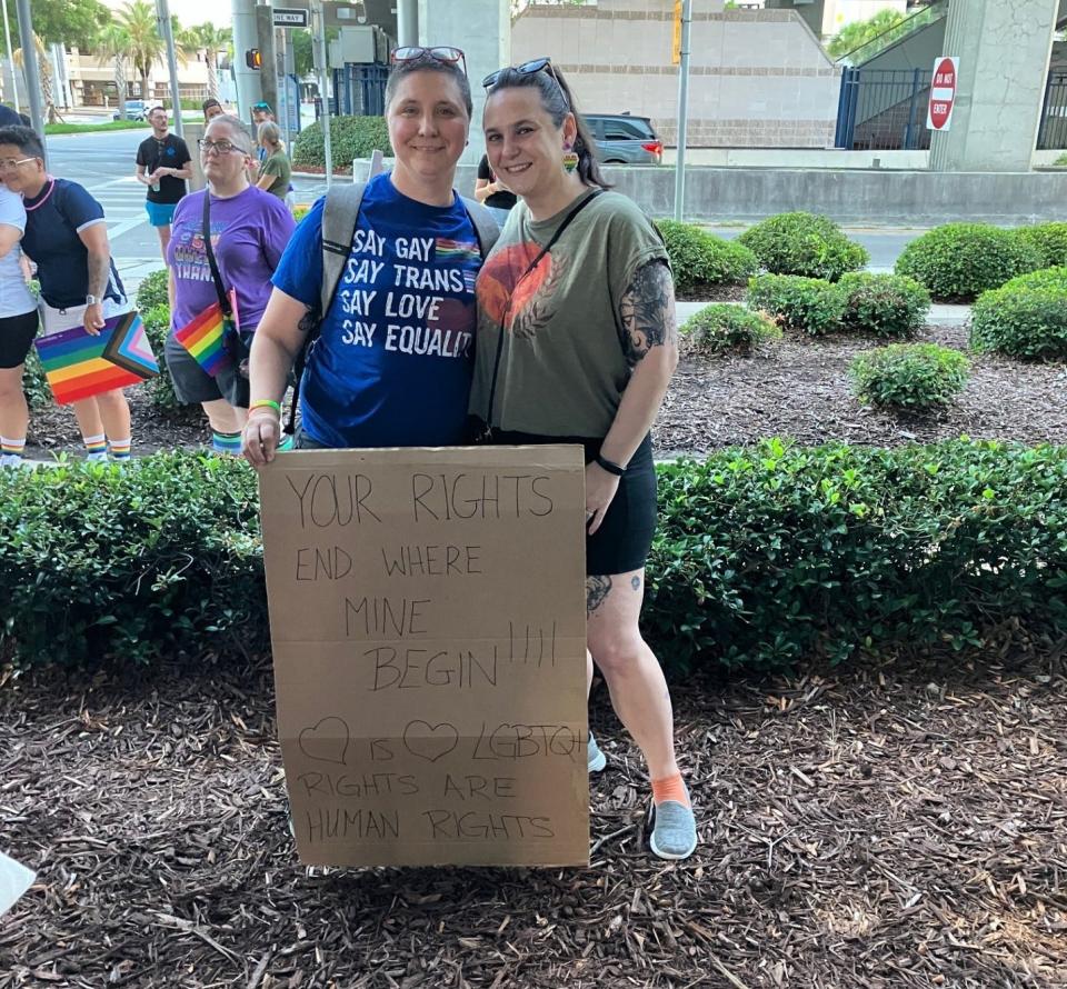 Shannan and Karla Foley brought a handmade protest sign to the 2024 Acosta Bridge Pride March where they were among hundreds of participants who marched across the Acosta Bridge in a peaceful demonstration Saturday nigh to raise awareness and show support for the LGBTQ+ community.