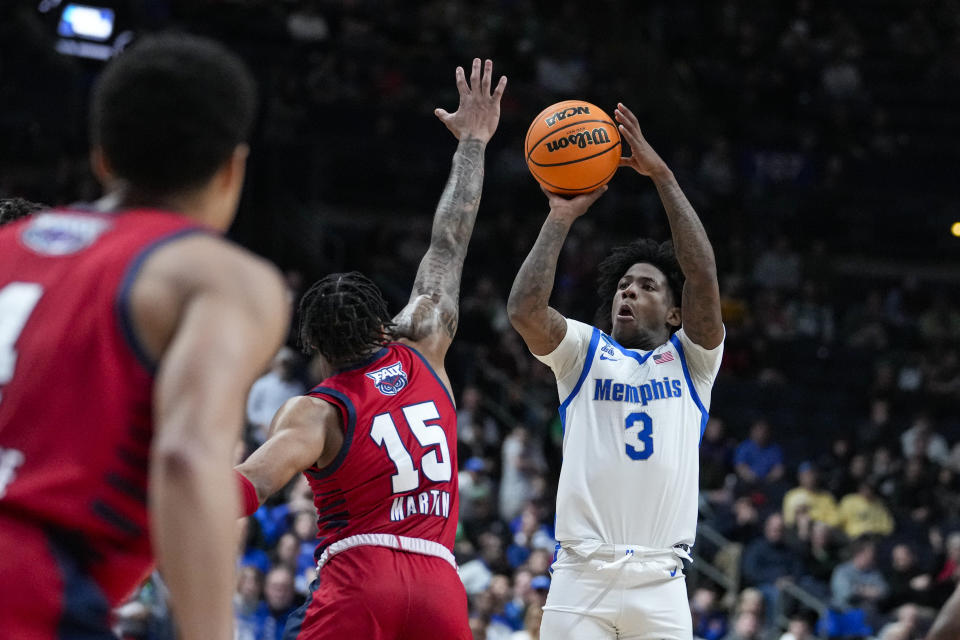 Memphis guard Kendric Davis (3) shoots over Florida Atlantic guard Alijah Martin (15) in the first half of a first-round college basketball game in the men's NCAA Tournament in Columbus, Ohio, Friday, March 17, 2023. (AP Photo/Michael Conroy)