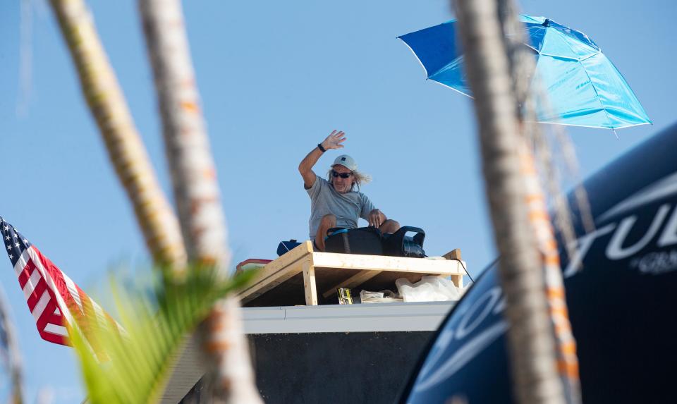 Rick Loughrey battles the hot weather on Monday, August 7, 2023, while continuing to protest from the roof of his Fort Myers Beach garage. He is protesting code regulations that his garage must come into compliance with new FEMA regulations. The entities are still at a stalemate.