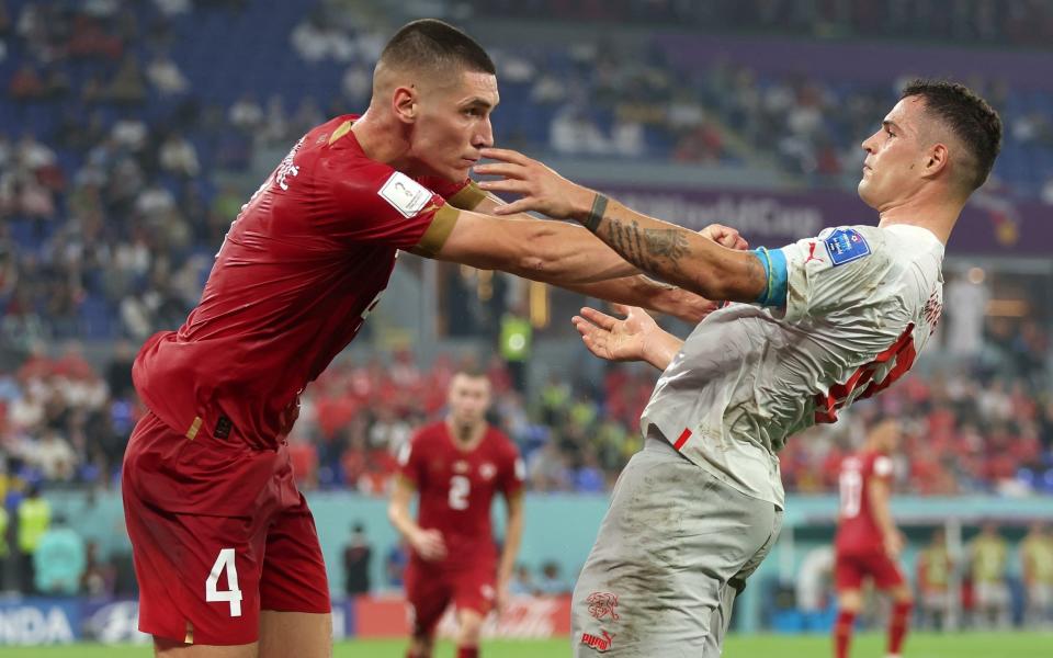 Granit Xhaka of Switzerland and Nikola Milenkovic of Serbia square off during the FIFA World Cup Qatar 2022 Group G match between Serbia and Switzerland - Getty Images