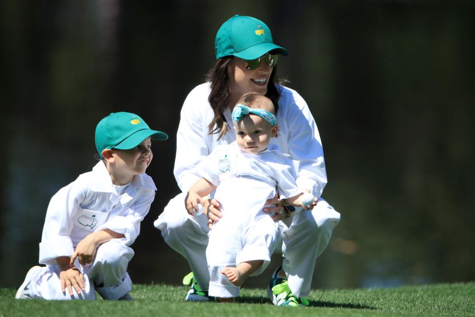 AUGUSTA, GEORGIA - APRIL 10: Angela Akins Garcia, wife of Sergio Garcia of Spain (not pictured) and their daughter Azalea, look on with Lex, son of Paul Casey of England (not pictured) during the Par 3 Contest prior to the Masters at Augusta National Golf Club on April 10, 2019 in Augusta, Georgia. (Photo by Andrew Redington/Getty Images)