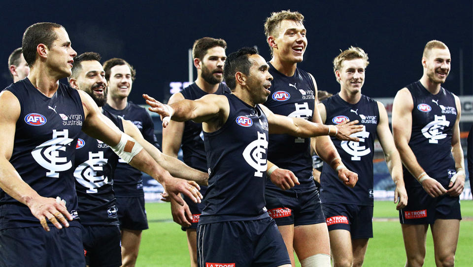 Eddie Betts and Carlton teammates celebrating after a win.