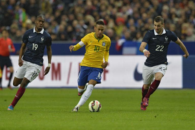Brazil's forward Neymar (C) vies with France's Morgan Schneiderlin (R) and Geoffrey Kondogbia during their friendly football match on March 26, 2015 at the Stade de France in Saint-Denis, north of Paris