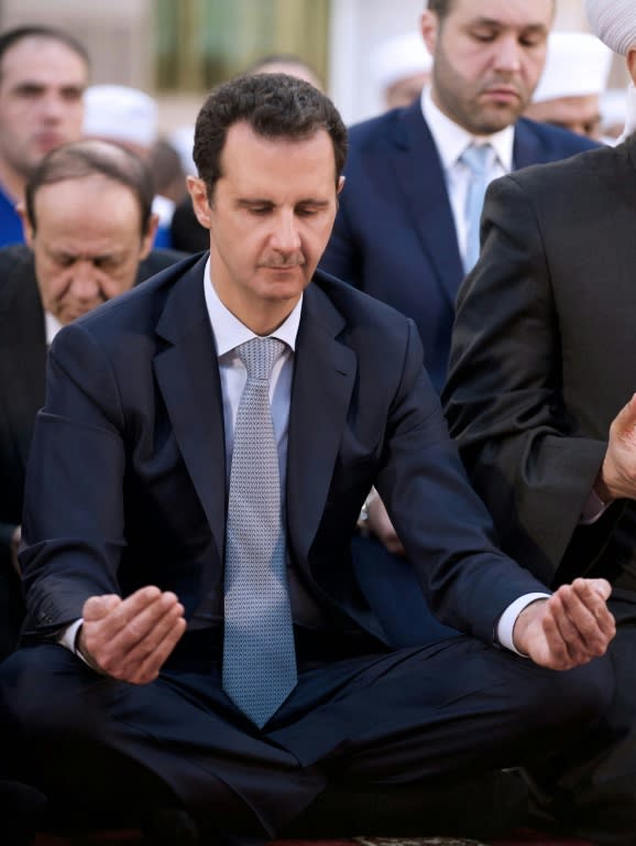 Bashar al-Assad performs the morning prayer on the Muslim holiday of Eid al-Adha at the Al-Adel mosque in Damascus on September 24, 2015