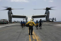 CORRECTS DATE - In this Friday, May 17, 2019, photo, released by the U.S. Navy, sailors work around an MV-22 Osprey as it lands on the flight deck of the Nimitz-class aircraft carrier USS Abraham Lincoln in the Arabian Sea. Commercial airliners flying over the Persian Gulf risk being targeted by "miscalculation or misidentification" from the Iranian military amid heightened tensions between the Islamic Republic and the U.S., American diplomats warned Saturday, May 18, 2019, even as both Washington and Tehran say they don't seek war. (Mass Communication Specialist 3rd Class Amber Smalley/U.S. Navy via AP)